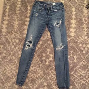 Ripped jeans with cover holes